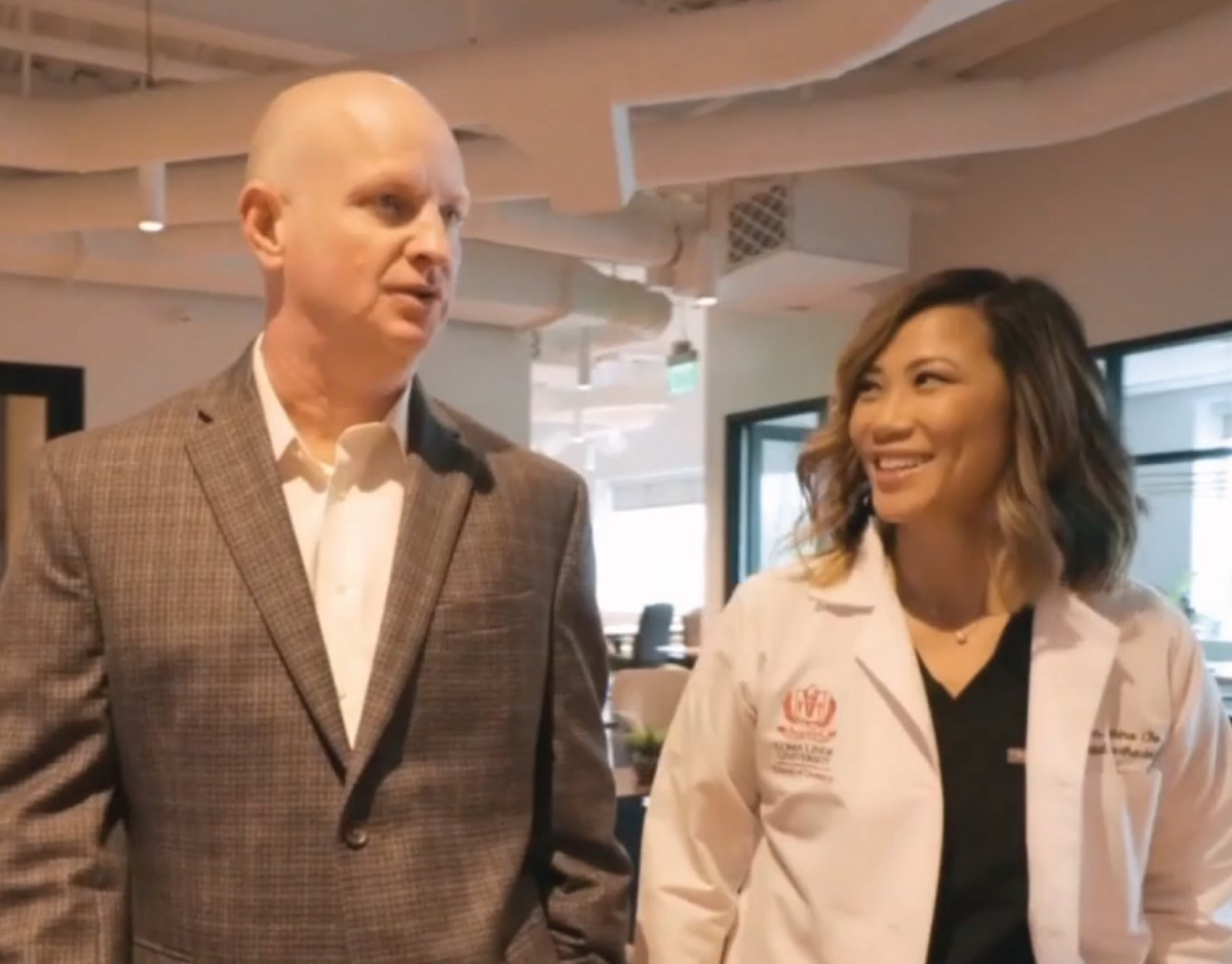 Dr. Keadle and Dr. Chu walking in office, talking